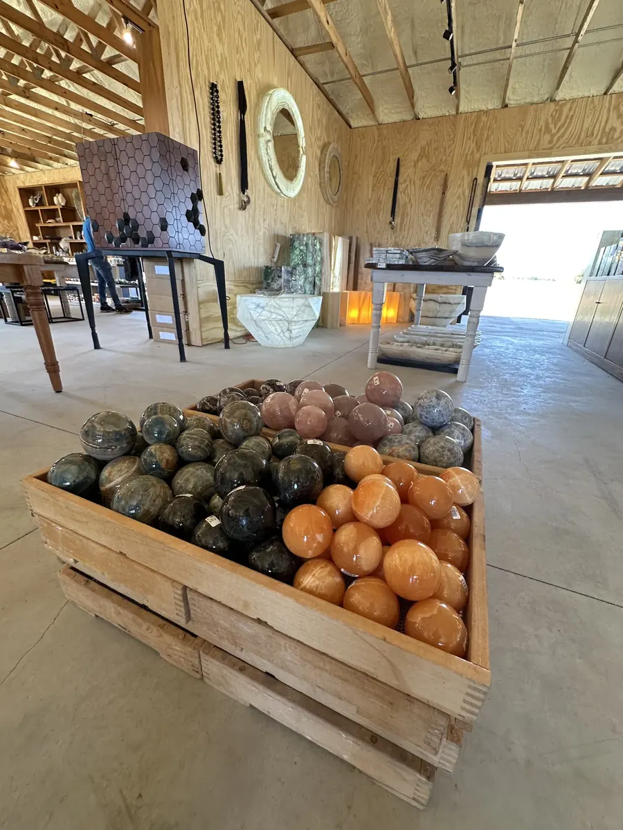 Crates of polished stone spheres in earthy colors at The Hive