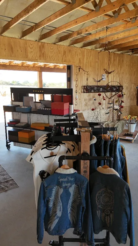 Clothing displayed on wooden racks inside The Hive