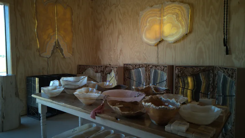 Natural stone bowls and colorful slabs displayed inside The Hive