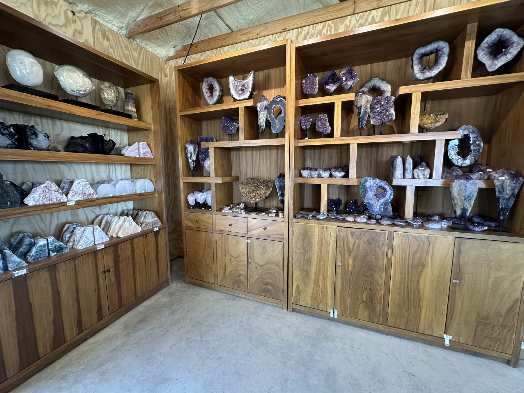 Shelves lined with geodes, crystals and mineral specimens at The Hive