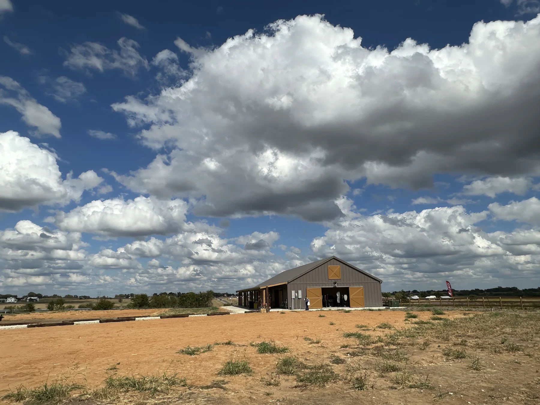 The Hive venue beneath dramatic clouds in the Texas countryside